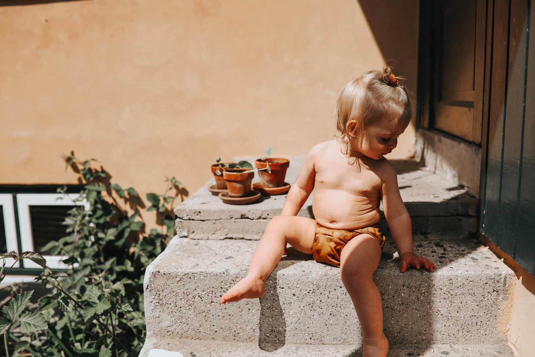 Baby on stairs with cloth diaper on