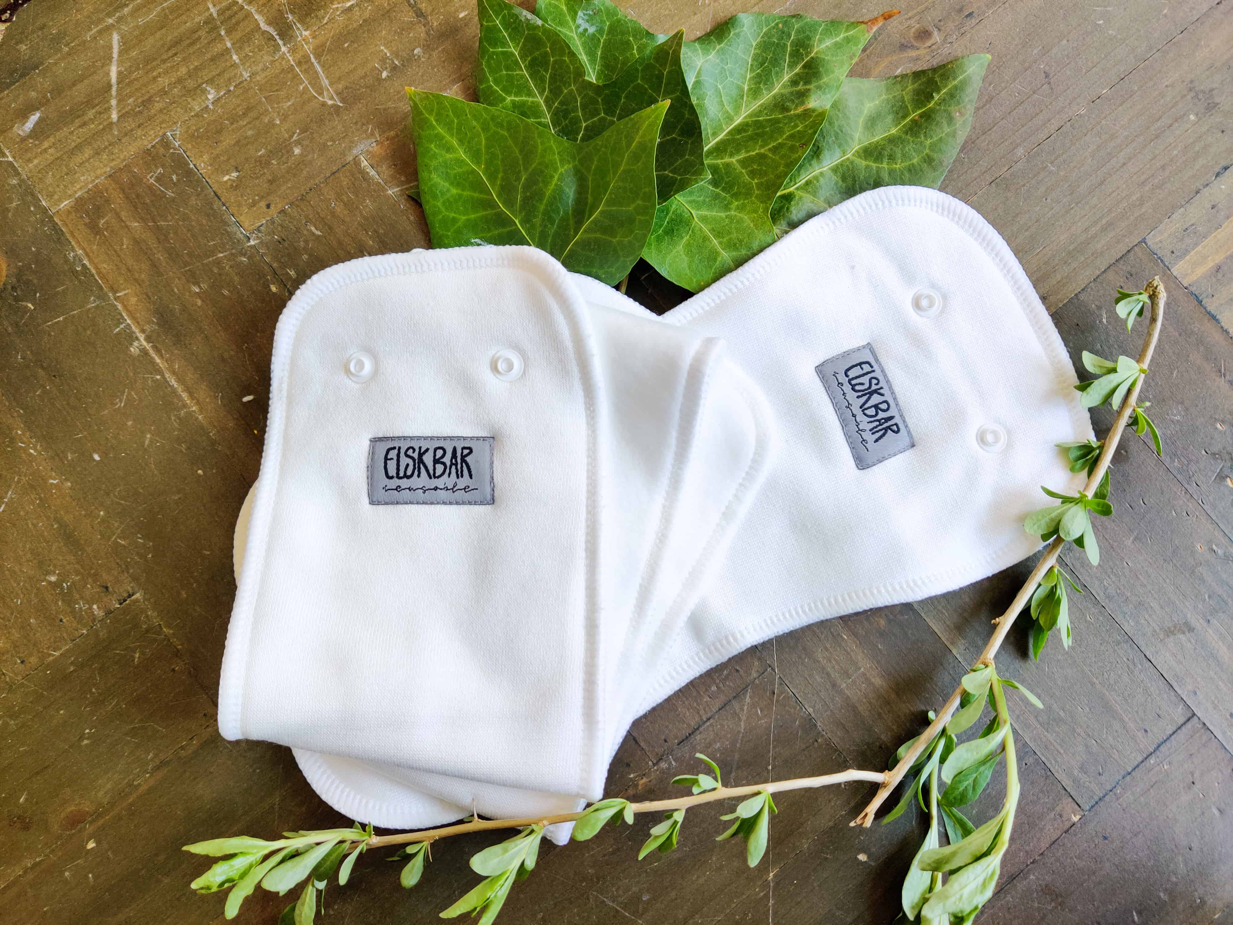 two cloth diaper inserts with leaves